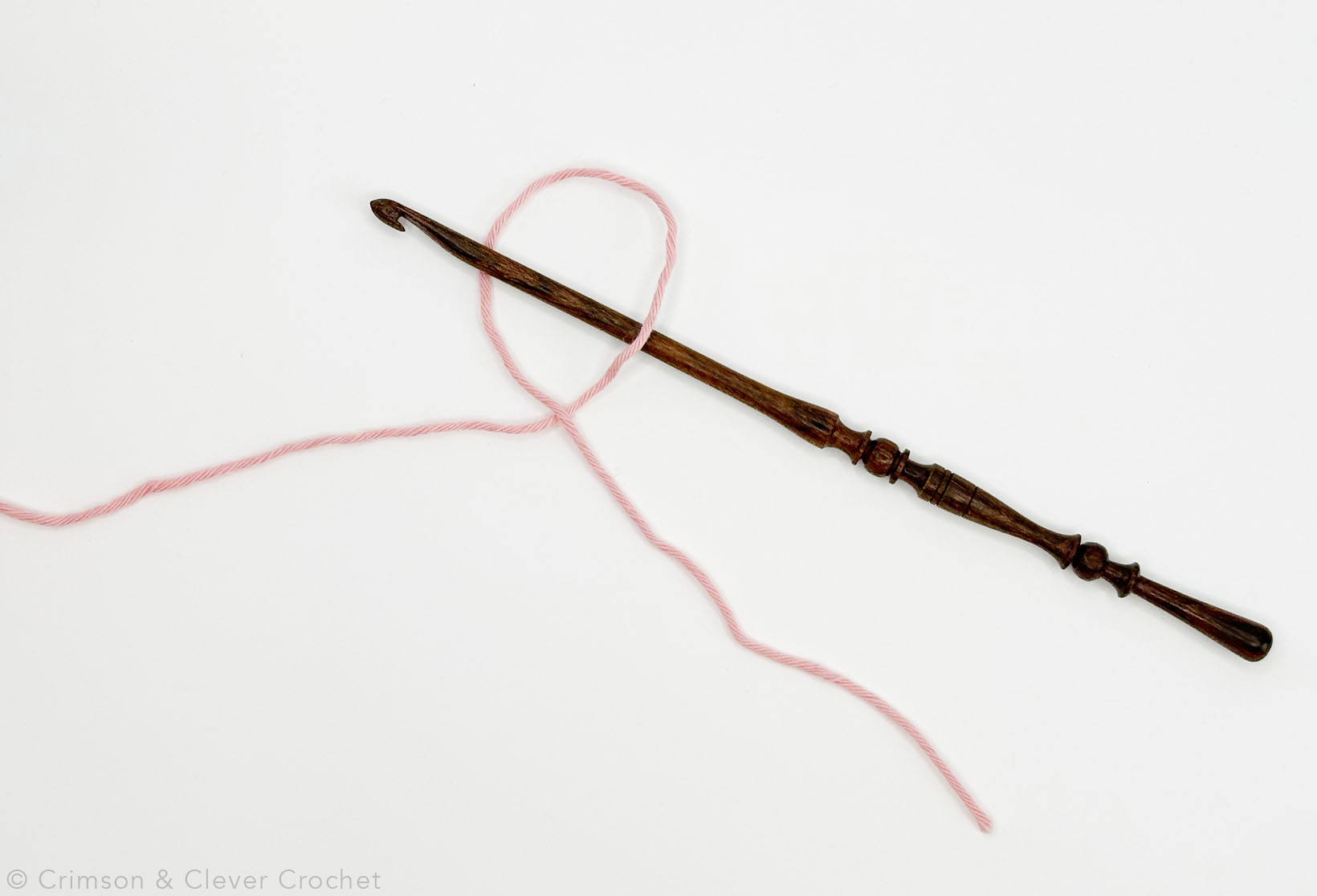 Put your hook into the first loop as pictured.