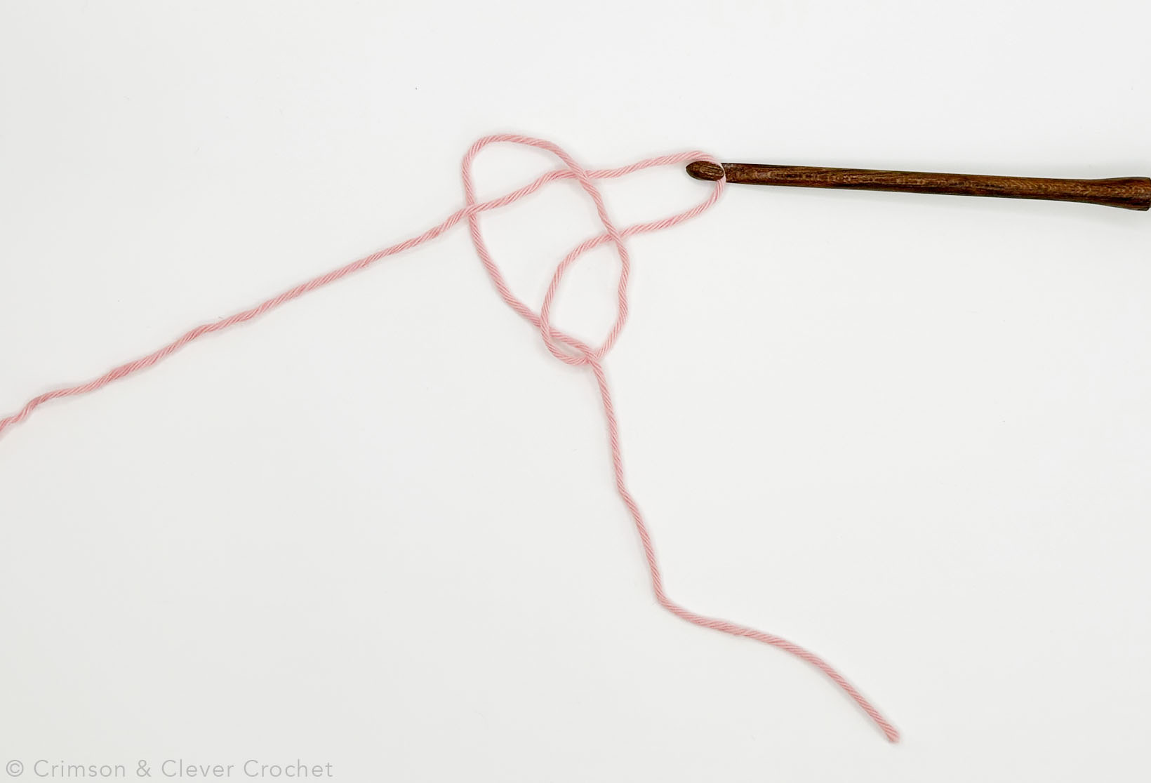 Pull the working end through the first loop to make another loop.